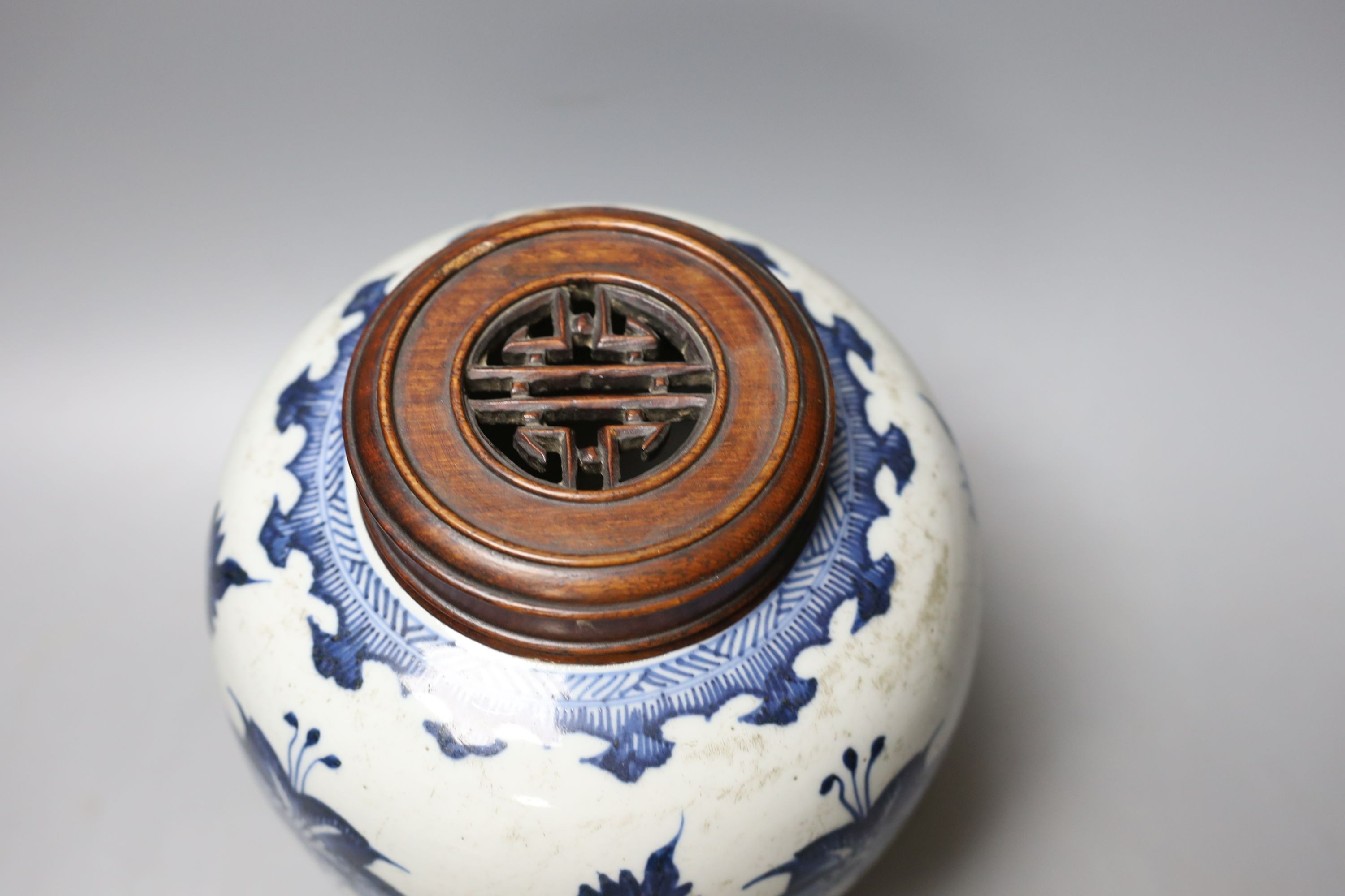 A 18th/19th century Chinese blue and white jar and wood cover - 22cm high